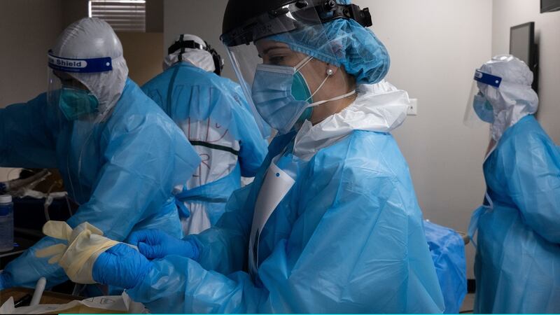 Medical staff members prepare to perform a treatment on a patient suffering from the coronavirus disease (COVID-19) in the COVID-19 intensive care unit (ICU) at the United Memorial Medical Center on November 14, 2020 in Houston, Texas. According to reports, Texas has reached over 1,070,000 cases, including over 19,900 deaths. (Photo by Go Nakamura/Getty Images)