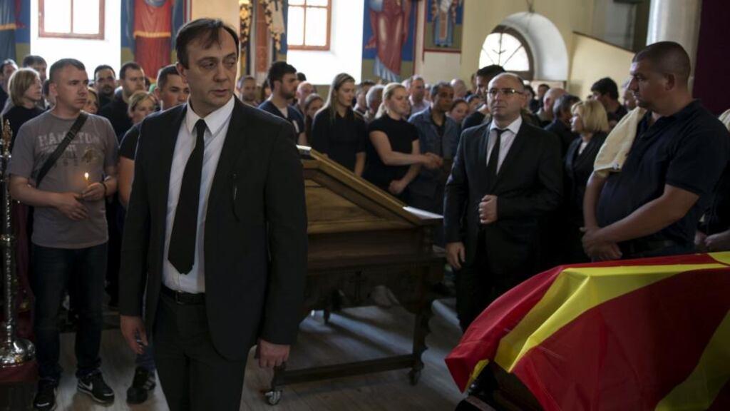 State security chief Saso Mijalkov walking by the coffin of  policeman Sasho Samoilovski this week. In a resignation letter yesterday, Mr Mijalkov said the centre-left opposition, led by Zoran Zaev, had caused the crisis with its “anti-state behaviour”. Photograph: Marko Djurica/Reuters