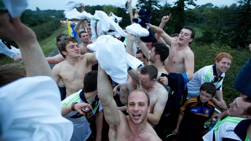 The Clare players celebrate on the bus on their way to Newmarket-on-Fergus on yesterday’s homecoming tour. Photograph: Seán Curtin