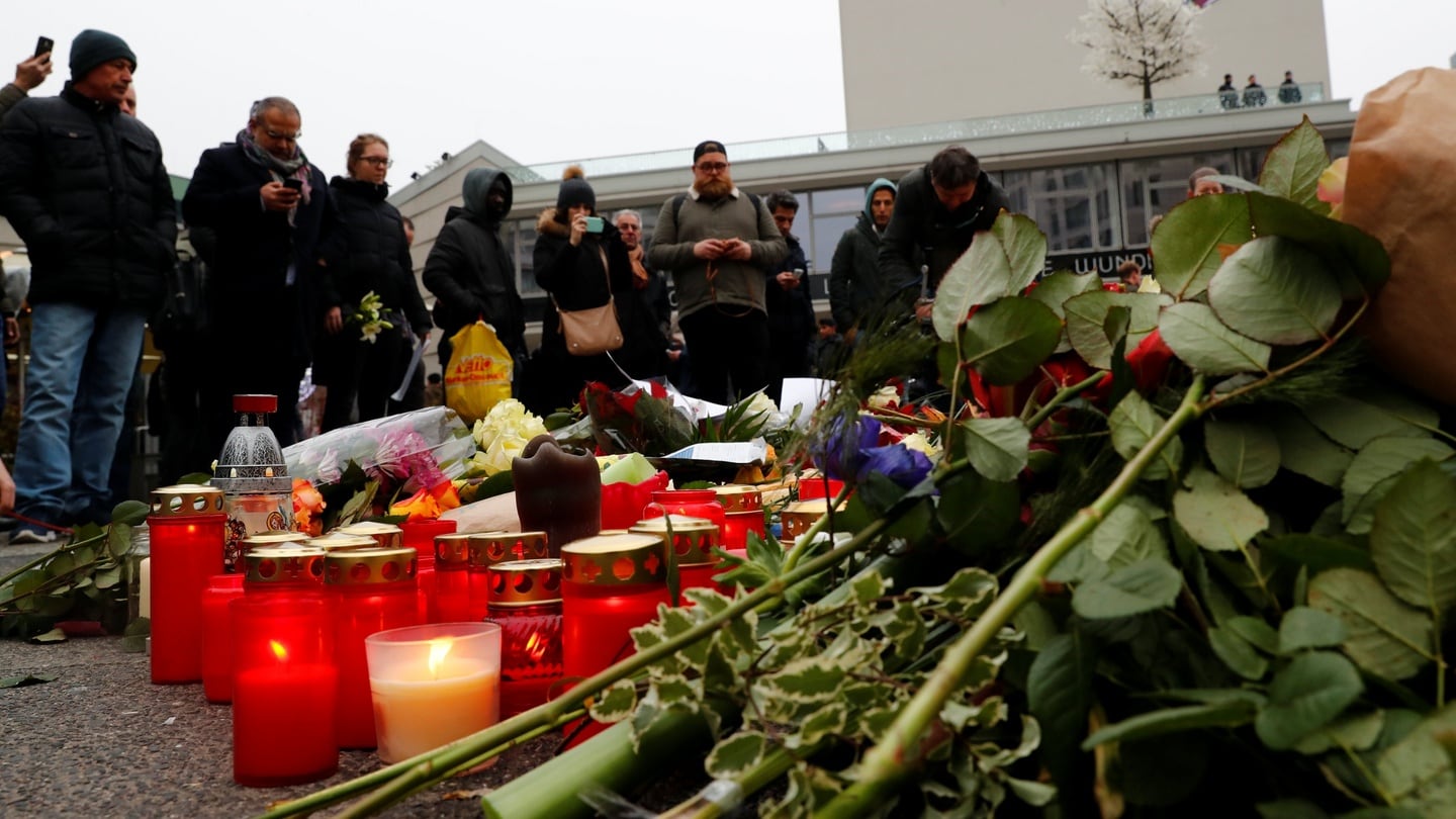 Flowers and candles are placed at the scene. Photograph: Pawel Kopczynski/Reuters