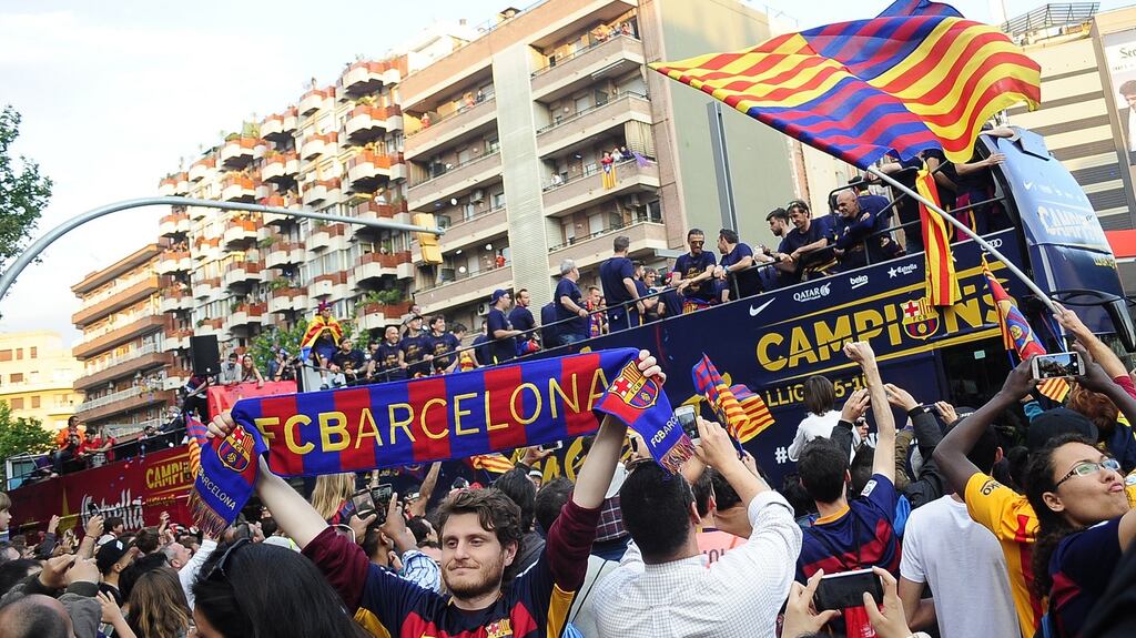 Barcelona fans celebrate alongside the team bus carrying La Liga trophy. Photograph: Joan Cros/NurPhoto via Getty Images