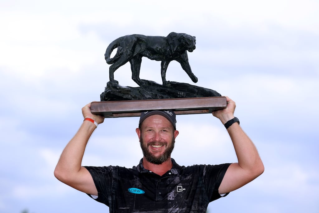 Ockie Strydom of South Africa lifts the Alfred Dunhill Championship trophy. Photograph: Warren Little/Getty Images