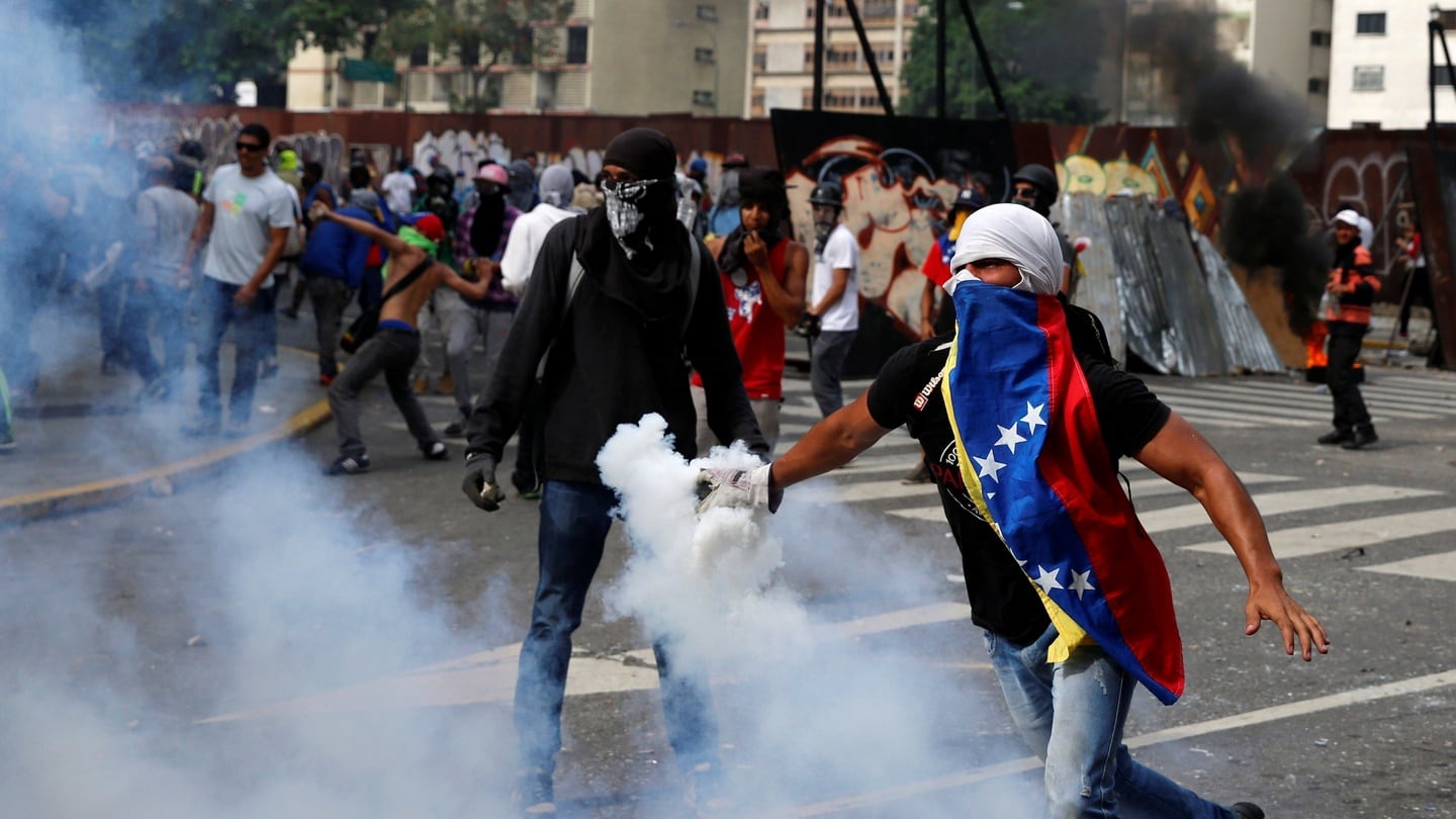 Opposition demonstrators clash with riot police during the “mother of all marches” against Venezuela’s President Nicolas Maduro in Caracas on Wednesday. Photograph: Marco Bello/Reuters
