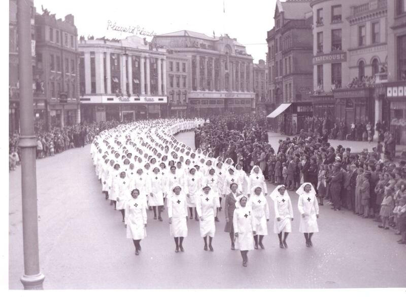 Watched by large crowds, many in uniform, members of the Army Nursing Service parade through Patrick Street, Cork, on the conclusion of the 1942 Blackwater Exercises. (Military Archives)