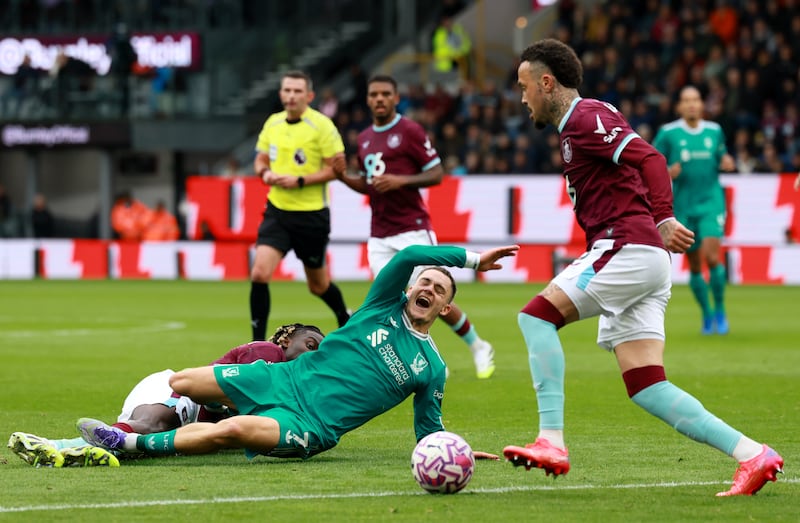 Burnley's Lesley Ugochukwu fouls Liverpool's Florian Wirtz resulting in a red card. Photograph: Richard Sellers/PA