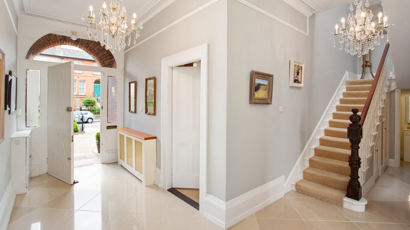 The stairs are carpeted with a soft runner, but the eye is drawn up by a clever skylight that emphasises the height of the stairwell