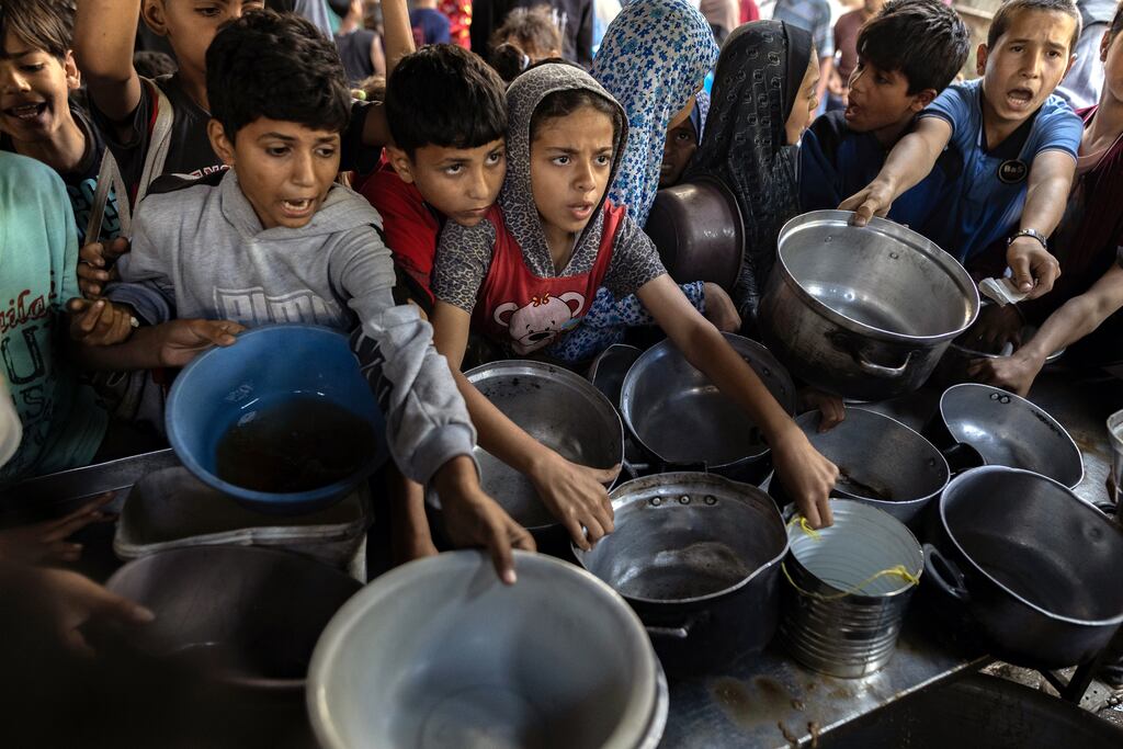 Children ask for food in Gaza, where at least 59,000 people have been killed in Israeli attacks and starvation is rife. File photograph: Saher Alghorra/The New York Times