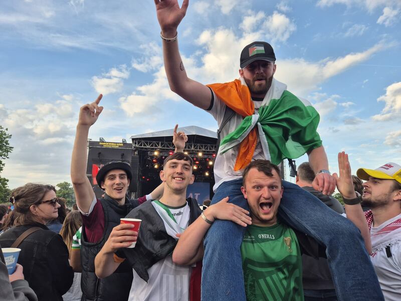 Kneecap fans Dan Croy from Galway with his friend, Tom O'Connor on his shoulders, beside fellow Irishman Tommy Kelly. All live in London
Photograph: Siobhán Reynolds