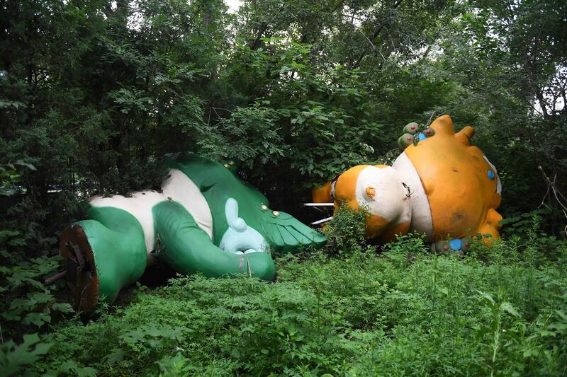 Nini (L) and Yingying, two of the five mascots for the 2008 Beijing Olympic Games, lying among trees behind an abandoned, never-completed mall in Beijing. A decade after the city hosted the 2008 Olympics, its legacy remains unmistakable. For better or worse, the Games changed the face of Beijing: from the iconic Bird's Nest stadium to the blocks of ancient homes bulldozed in an Olympic building frenzy. Photograph: AFP PHOTO / GREG BAKER