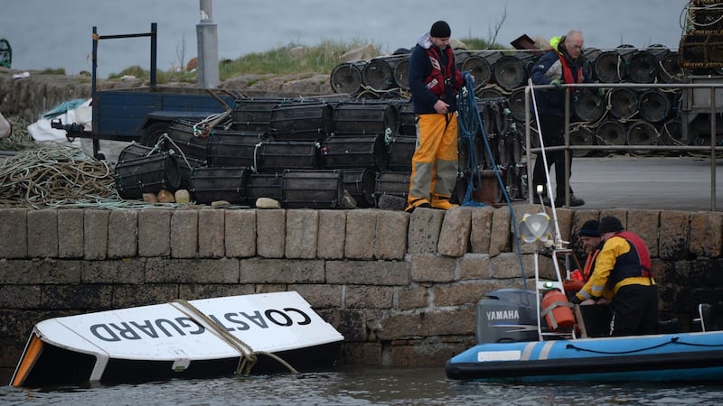 Debris from the helicopter is taken to the pier in Blacksod, Co Mayo. Photograph: Dara Mac Dónaill /