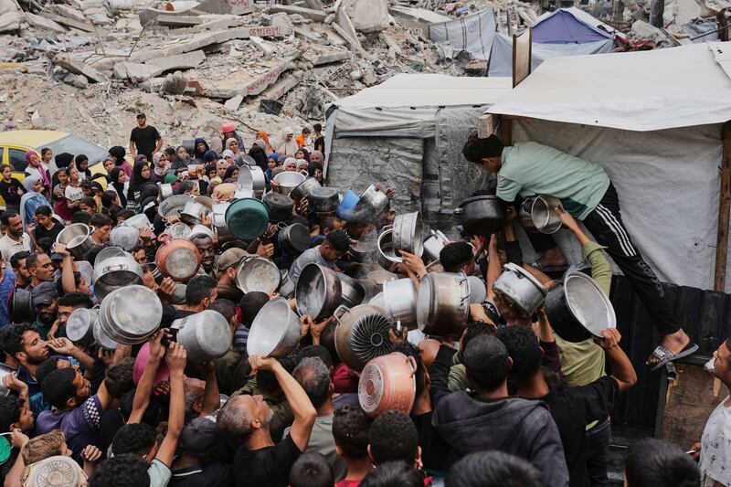 Palestinians struggle to get donated food at a community kitchen in Jabalia, northern Gaza. Photograph: Jehad Alshrafi/AP