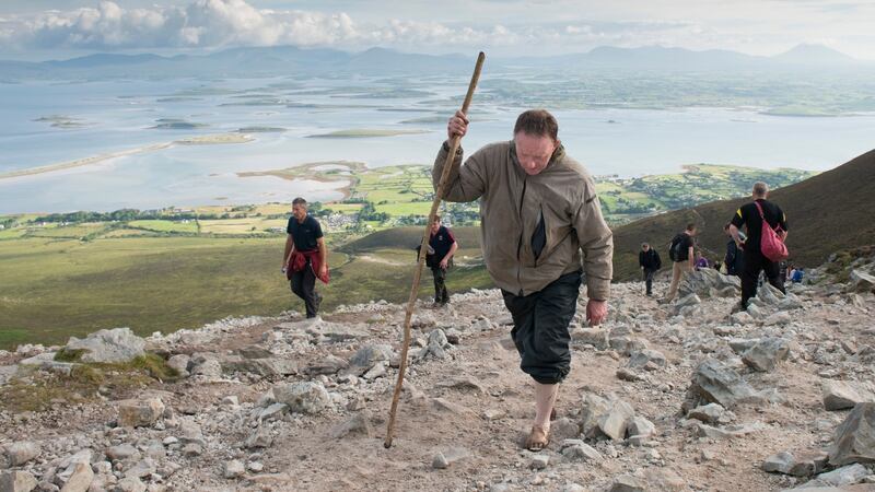Pilgrim Chris Moran from Cross, Co. Mayo cilmb Croagh Patrick on Reek Sunday, the annual pilgrimage day. Photograph: Michael Mc Laughlin