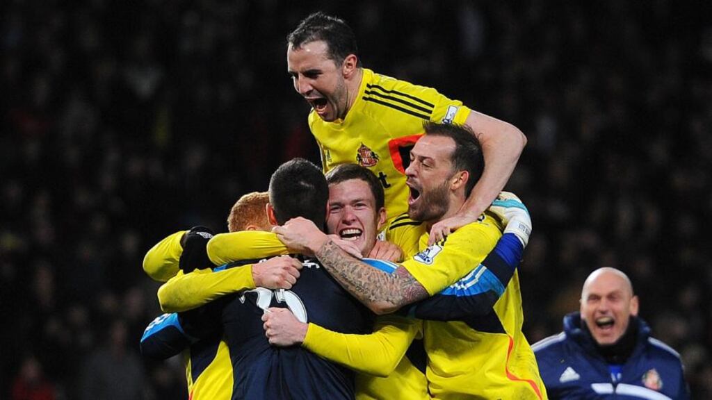 Sunderland’s Vito Mannone celebrates with team-mates after Manchester United’s Rafael Da Silva’s missed penalty during the Capital One Cup semi-final second leg at Old Trafford. Photograph: Martin Rickett/PA Wire.