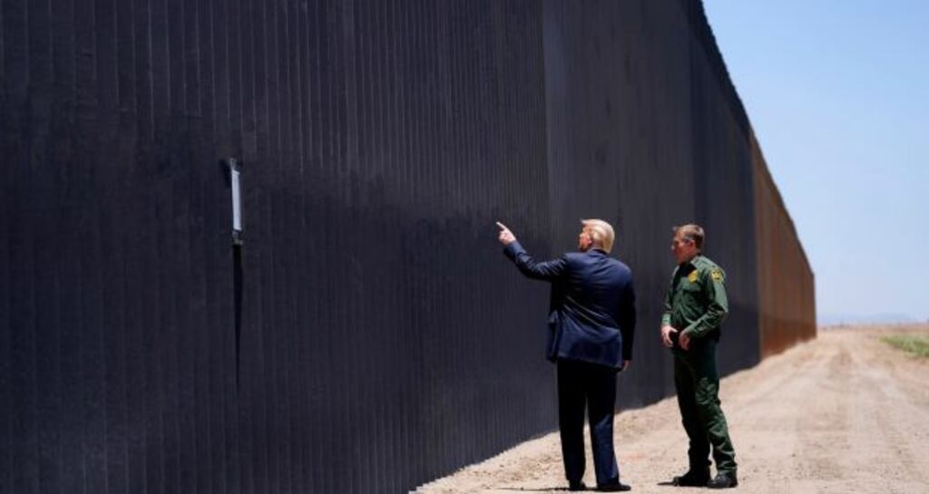 Donald Trump at the border wall. President Biden ordered a freeze on all border-wall projects. File photograph: AP