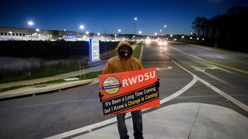 A union supporter stands outside the Amazon.com BHM1 fulfillment centre in Bessemer, Alabama. Photograph: Patrick T Fallon / AFP