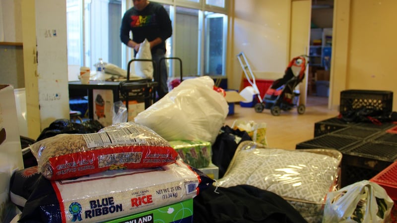 Hugo Castro, head of Border Angels’ Tijuana operations, is pictured behind piles of donated goods. Photograph: Stephen Starr