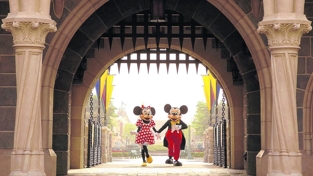 Mickey and Minnie Mouse are seen walking through Sleeping Beauty Castle at the Disneyland Park in Hong Kong.