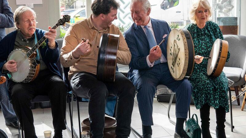 Prince Charles and Camilla join in with the band. Photograph: Arthur Edwards/Pool/AFP via Getty