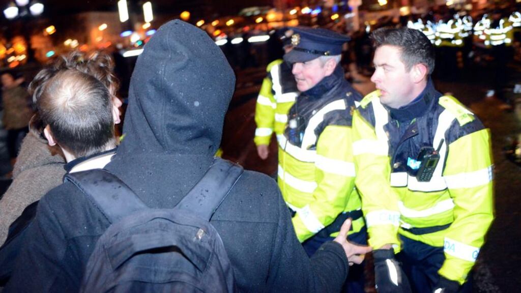Gardaí clear protestors from O’Connell Bridge in Dublin last night. Photograph: Dave Meehan