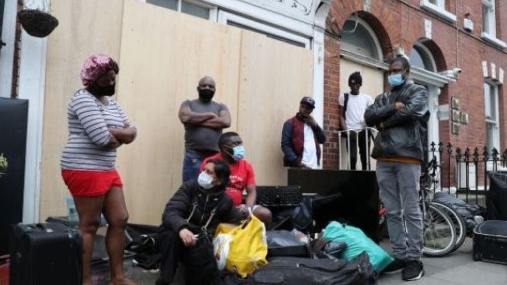 Residents stand outside their home on Berkeley Road, Dublin last Wednesday evening following their eviction. Photograph: Nick Bradshaw/The Irish Times