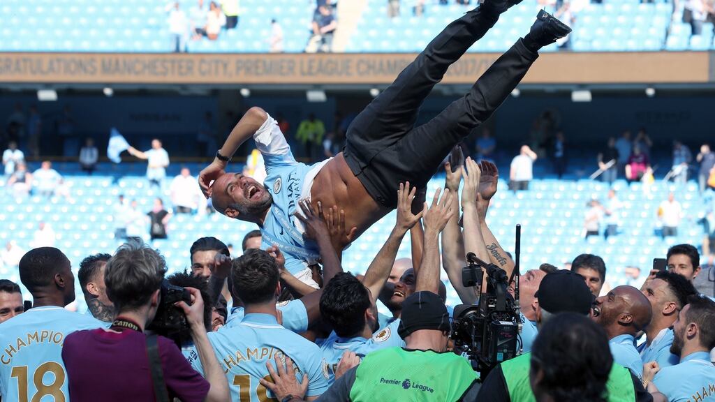 Manchester City manager Pep Guardiola is thrown  into the air as  players  celebrate winning the  Premier League  at the Etihad Stadium, Manchester. Photograph: Martin Rickett/PA Wire