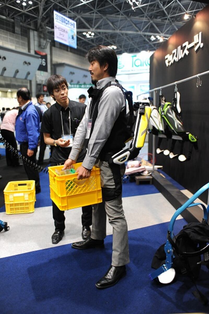 A man tries a robot-powered exoskeleton during a robot exhibition in Tokyo. Photograph: David Mareuil/Anadolu Agency/Getty Images