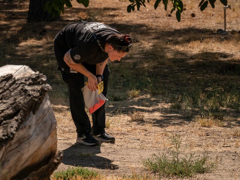 An investigator with the Utah Department of Public Safety scours a residential backyard next to Utah Valley University the day after the fatal shooting of Charlie Kirk in Orem, Utah. Photograph: Loren Elliott/The New York Times