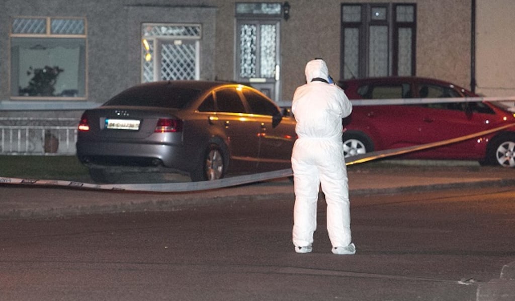 A Garda forensics officer examines the scene on Walsh Road, Drumcondra, where a vehicle was found abandoned shortly after the shooting. Photograph: Gareth Chaney/Collins