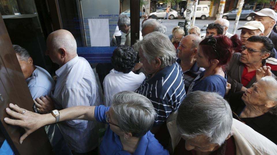 Pensioners struggle to enter an Alpha Bank branch in Athens on Wednesday. Photograph: Reuters