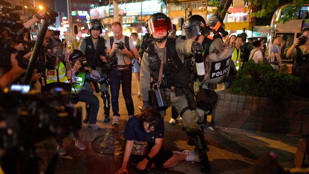 Police detain a protester on a street near Mong Kok police station in Hong Kong. Photograph: Nicolas Asfouri/AFP via Getty Images