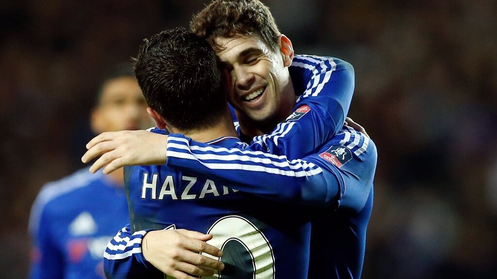 Oscar celebrates with Eden Hazard after scoring the third goal for Chelsea to complete his hat trick. Photograph: John Sibley/Reuters