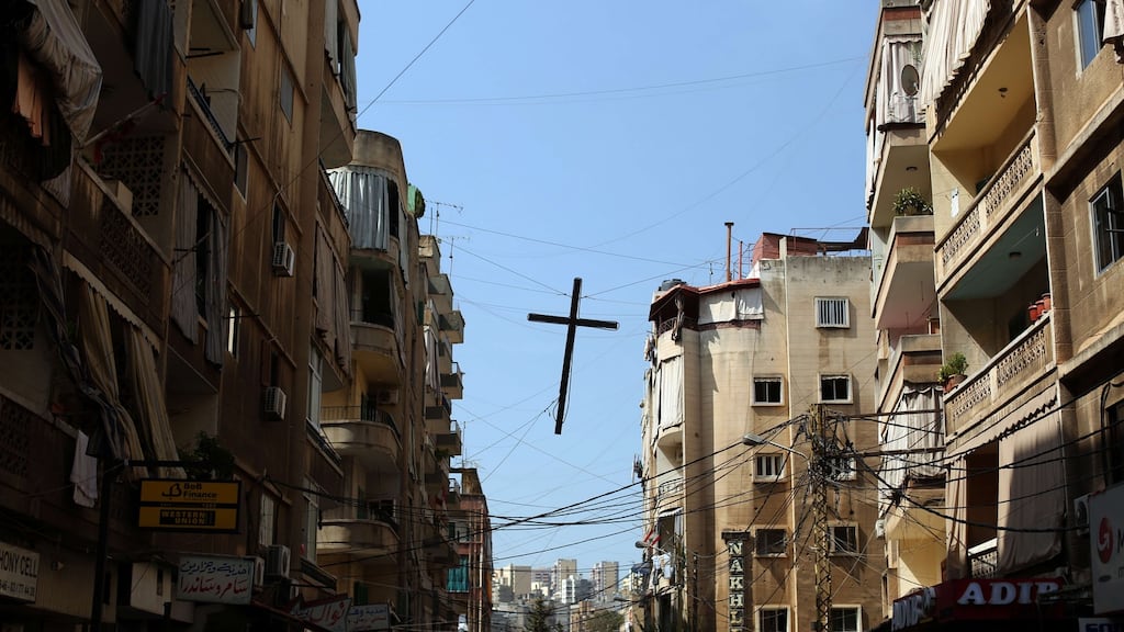 A cross hangs over the street in  Beirut, Lebanon. The document says if the current exodus continues, by 2020 there could be no Christians in Iraq, where persecution is “extreme”. Photograph: Patrick Baz/AFP/Getty Images