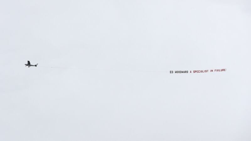 A plane flies over Turf Moor with a banner protesting against Manchester United’s chief executive Ed Woodward. It reads, ‘Ed Woodward a specialist in failure.’ Photograph: Martin Rickett/PA
