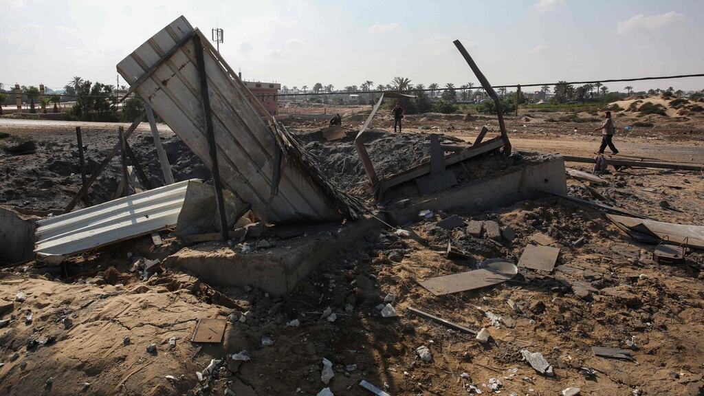 Palestinian men check the site of an Israeli air strike in Khan Yunis in the southern Gaza Strip on Friday. Photograph: Said Khatib/AFP/Getty Images