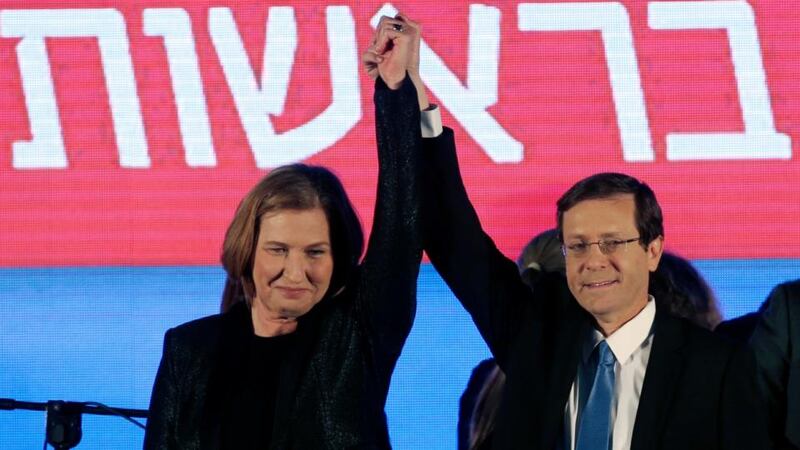 Isaac Herzog (right) and Tzipi Livni, joint leaders of Zionist Union, raise their arms at party headquarters in Tel Aviv. Photograph: Ronen Zvulun/Reuters