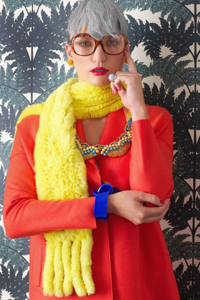 Orange coat €420, Harris Wharf, Brown Thomas. Scarf €195, Yves Saloman, Costume. Sunburst earrings €625, Sophie Epp, DesignYard. Neckpiece €95, Tatsiana Coquerel, cuff, €65, Capulet & Montague, Om Diva. Round Cabochon Ring Silver with Blue Lace Agate €95, Juvi