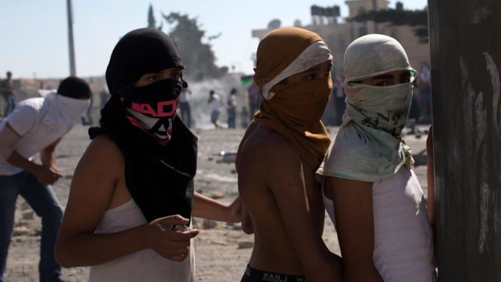 Masked young Palestinians during clashes  with Israeli police in the East Jerusalem area of Shuafat yesterday.  Photograph: EPA/Atef Safadi
