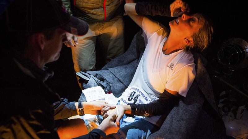 Courtney Dewaulter applies rewetting drops to avoid corneal edema caused by lack of sleep and the presence of dust on the trails, at the Loon Lake, California, aid station at mile 182 of the Tahoe 200 ultramarathon.