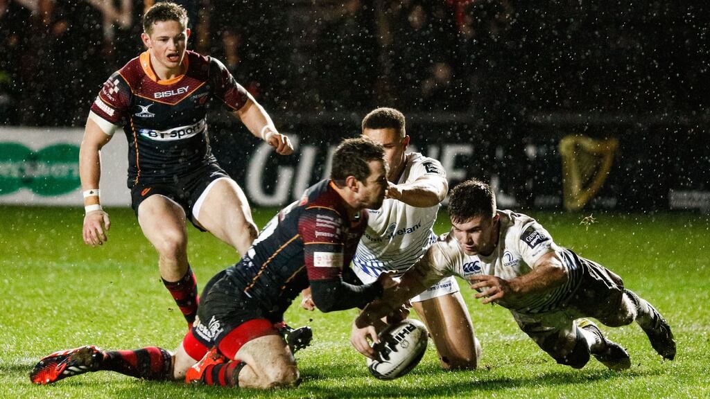Dragons’ Adam Warren is denied a try by Luke McGrath of Leinster. Photograph: Simon King/Inpho