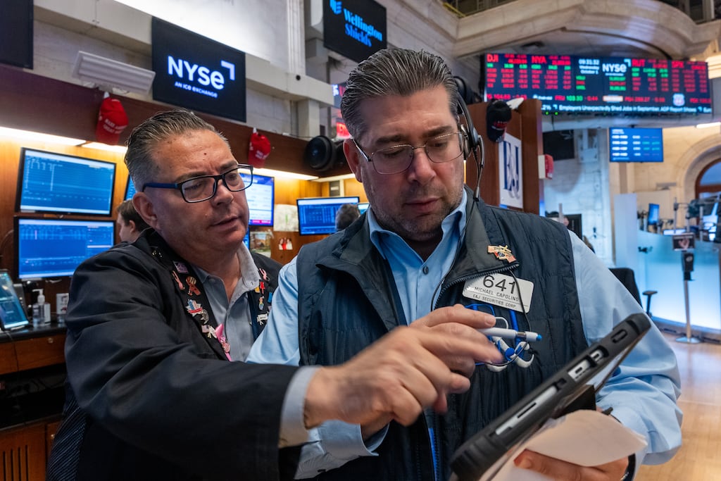 Traders work on the floor of the New York Stock Exchange. Photo by Spencer Platt/Getty Images