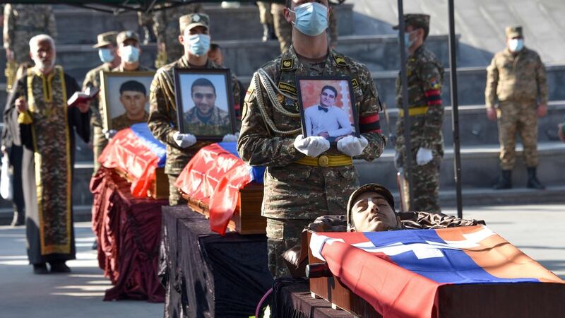 Armenian soldiers with coffins bearing the remains of others killed during the military conflict between Armenia and Azerbaijan over the disputed Nagorno-Karabakh region, at Yerablur Military Memorial Cemetery, Yerevan, on November 14th, 2020. Photograph: Karen Minasyan/AFP/Getty