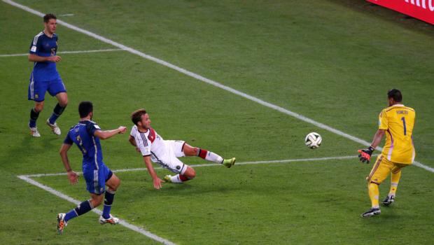 Germany’s Mario Götze  scores the winner  past Argentina goalkeeper Sergio Romero as Martin Demichelis (left) and  Ezequiel Garay look on at the   Maracana in Rio de Janeiro. Photograph: David Gray / Reuters