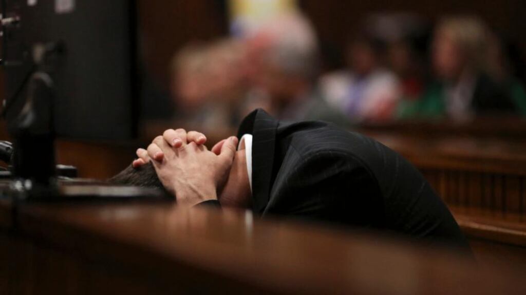 Olympic and Paralympic track star Oscar Pistorius puts his hands over his head, in the dock during his trial for the murder of his girlfriend Reeva Steenkamp, at the North Gauteng High Court in Pretoria today. Photograph: Siphiwe Sibeko/Reuters