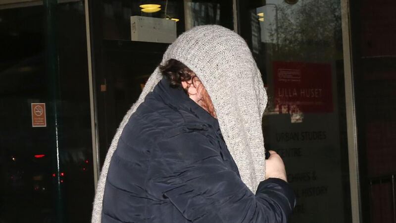 Jamie Penny covers his head as he leaves West London Magistrates court in London where he was charged with harassing comedian Eddie Izzard. Photograph: Philip Toscano/PA Wire