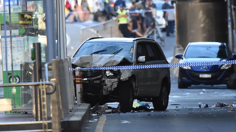 A white SUV sits in the middle of the road as police and emergency personnel work at the scene of where a car ran over pedestrians. Photograph: Mal Fairclough/AFP/Getty Images