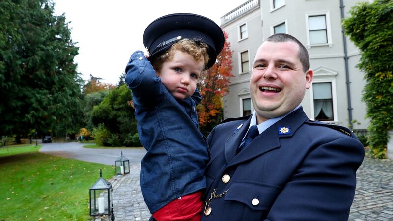 Garda Eoghan O’Neill, who was awarded a certificate of bravery for rescuing a woman from the sea, with his son Faolán (2), at the National Bravery Awards at Farmleigh House in Dublin. Photograph: Maxwells