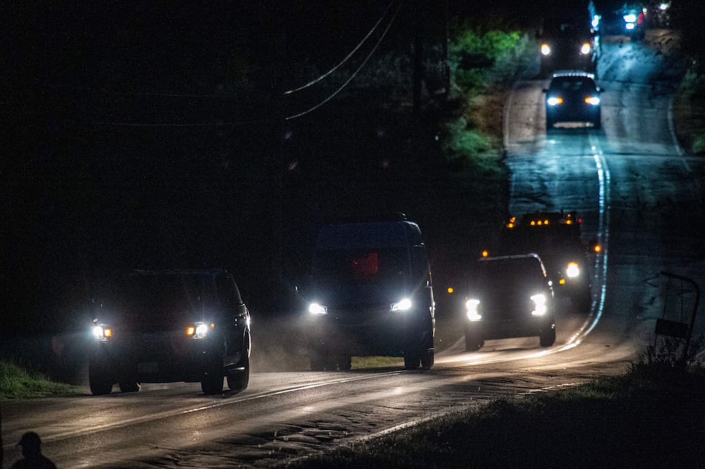 Police vehicles leave property belonging to Robert Card's relatives in Bowdoin, 25km away from Lewiston, Maine, the day after a mass shooting. Photograph: Joseph Prezioso/AFP via Getty Images