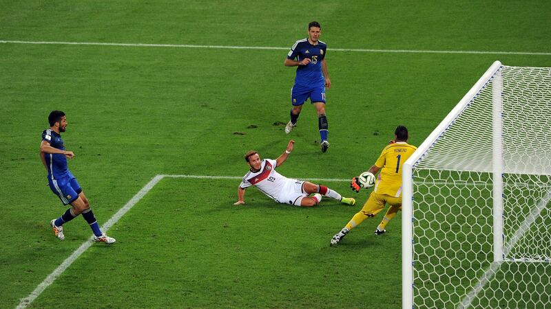 Gomez stretches to guide the ball past Sergio Romero and win the World Cup for Germany. Photo: Chris Brunskill/Getty Images