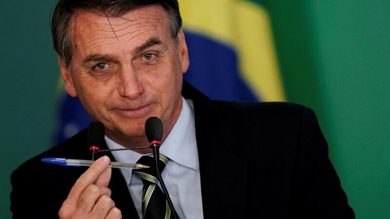 Brazil’s president Jair Bolsonaro during a signing ceremony of the decree to ease gun restrictions in Brazil. Photograph: Ueslei Marcelino/Reuters