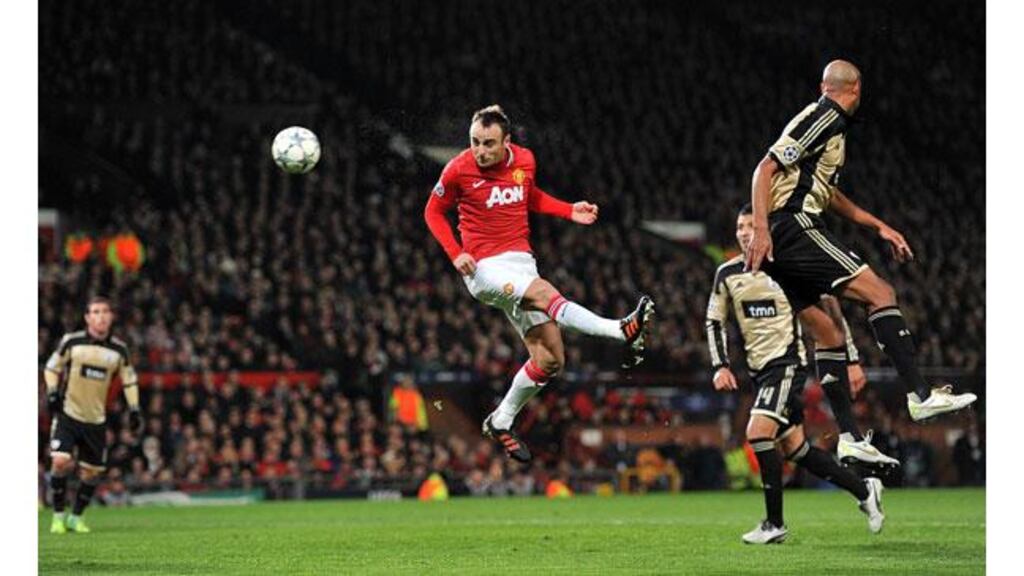 Manchester United’s Dimitar Berbatov scores his side’s first goal against Benfica during the Champions League Group C game at Old Trafford. – (Photograph: Martin Rickett/PA).